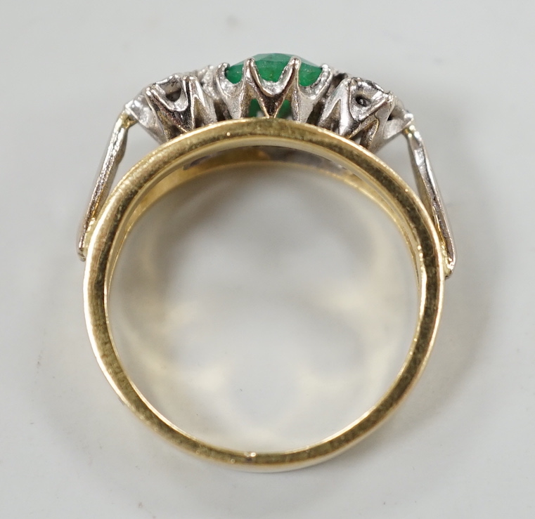 A modern yellow metal, emerald and diamond set three stone ring, size G, gross weight 3.8 grams.